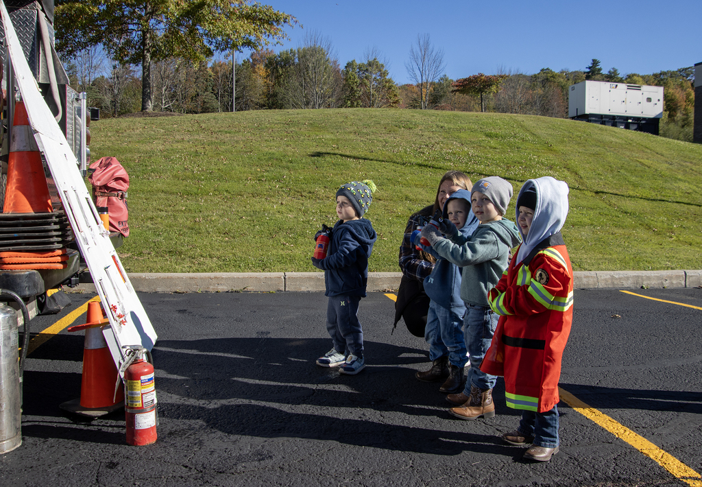 4 students and a teacher at the fire extinguisher activity