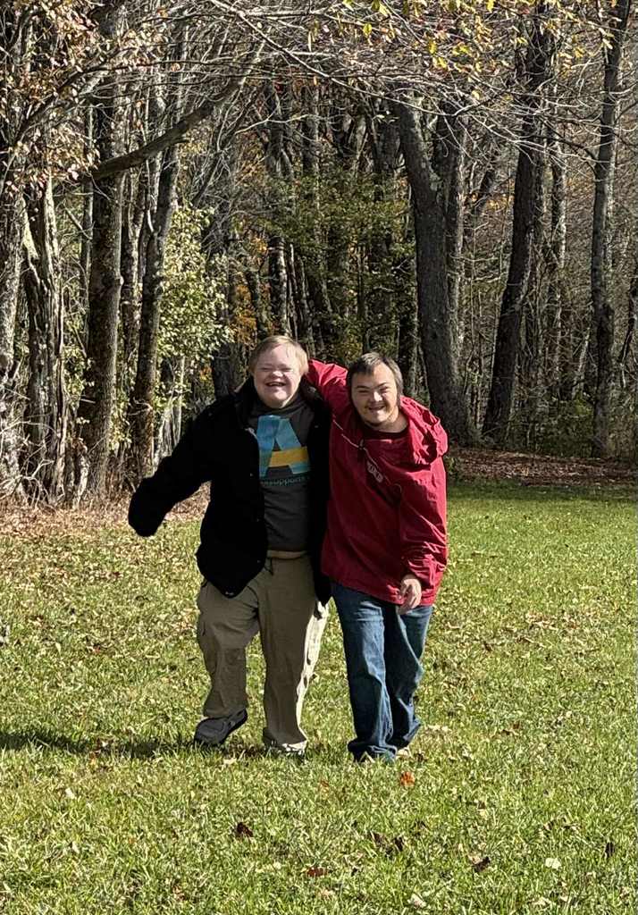 two friends walking arm in arm