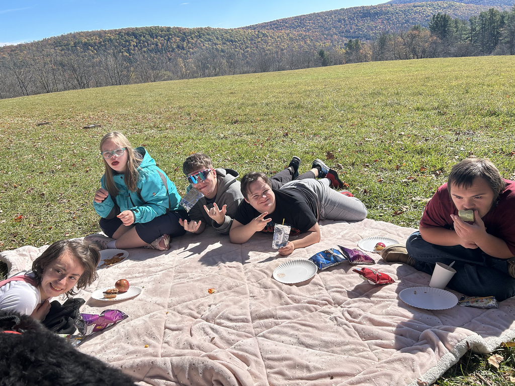 5 students lying on a blanket