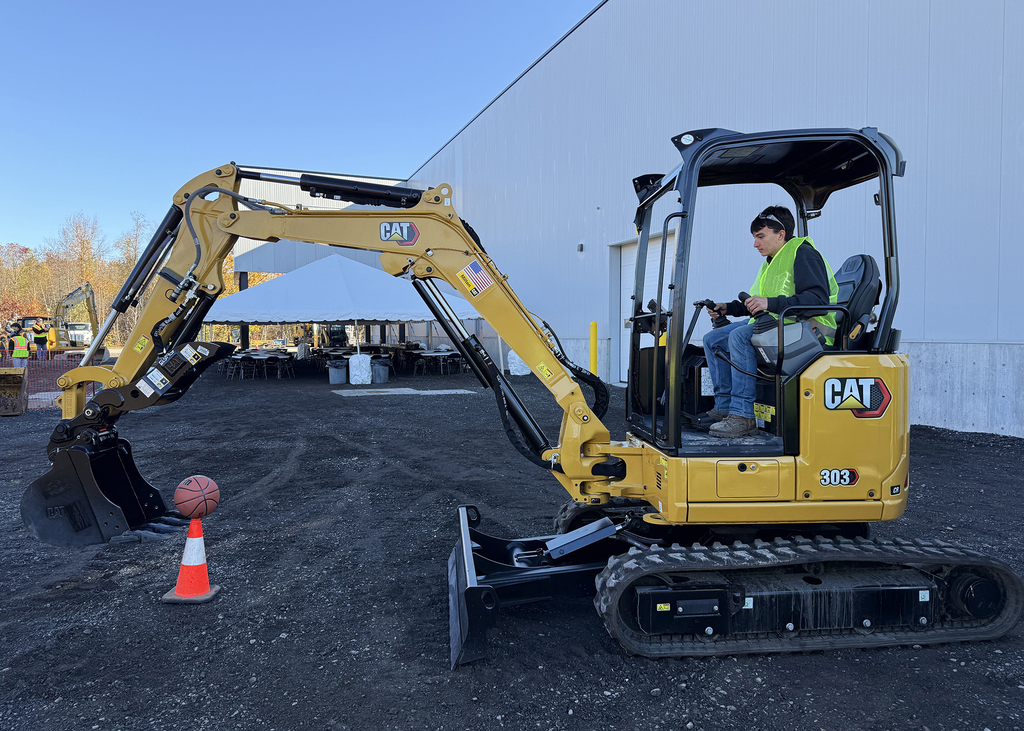 student operates excavator