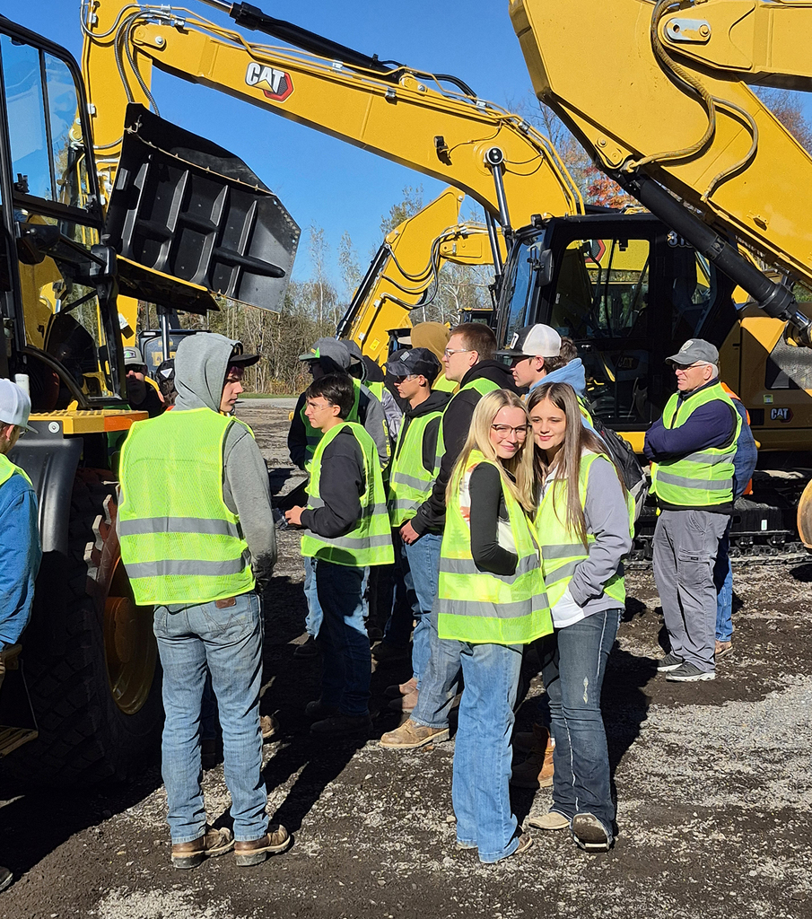 students outside looking at big equipment