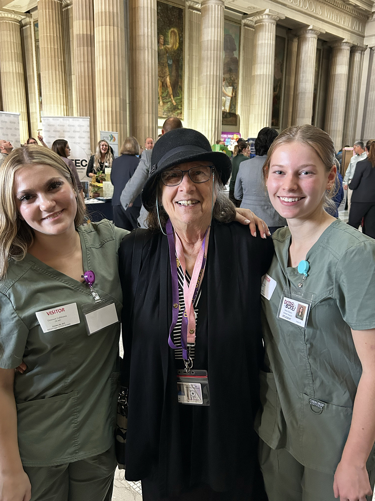 2 students pose with one of the Regents
