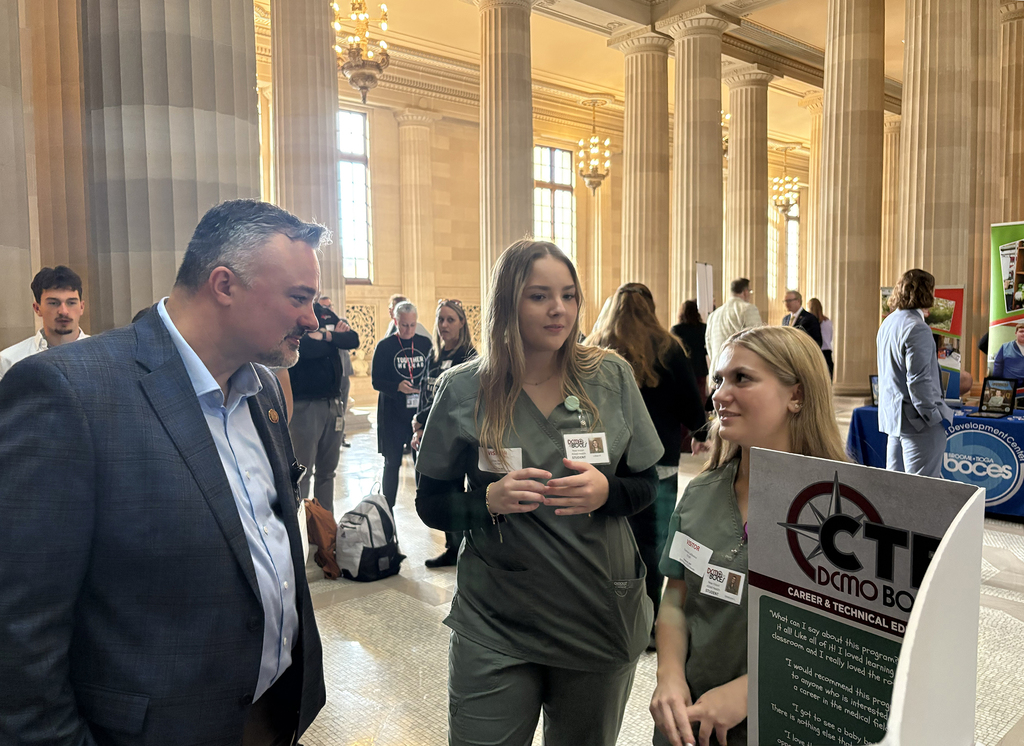 Regent talks with two New Visions students