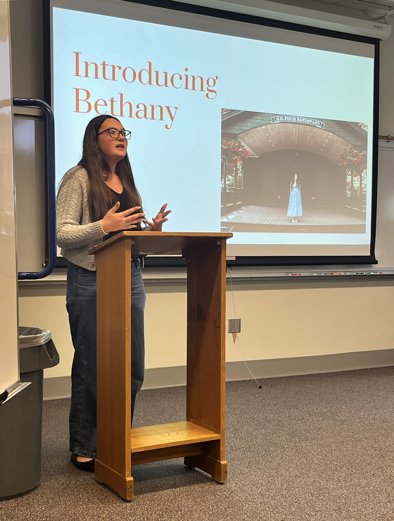 New Visions student delivers speech at podium