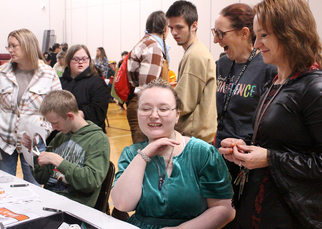 students and adults at activity table on Halloween