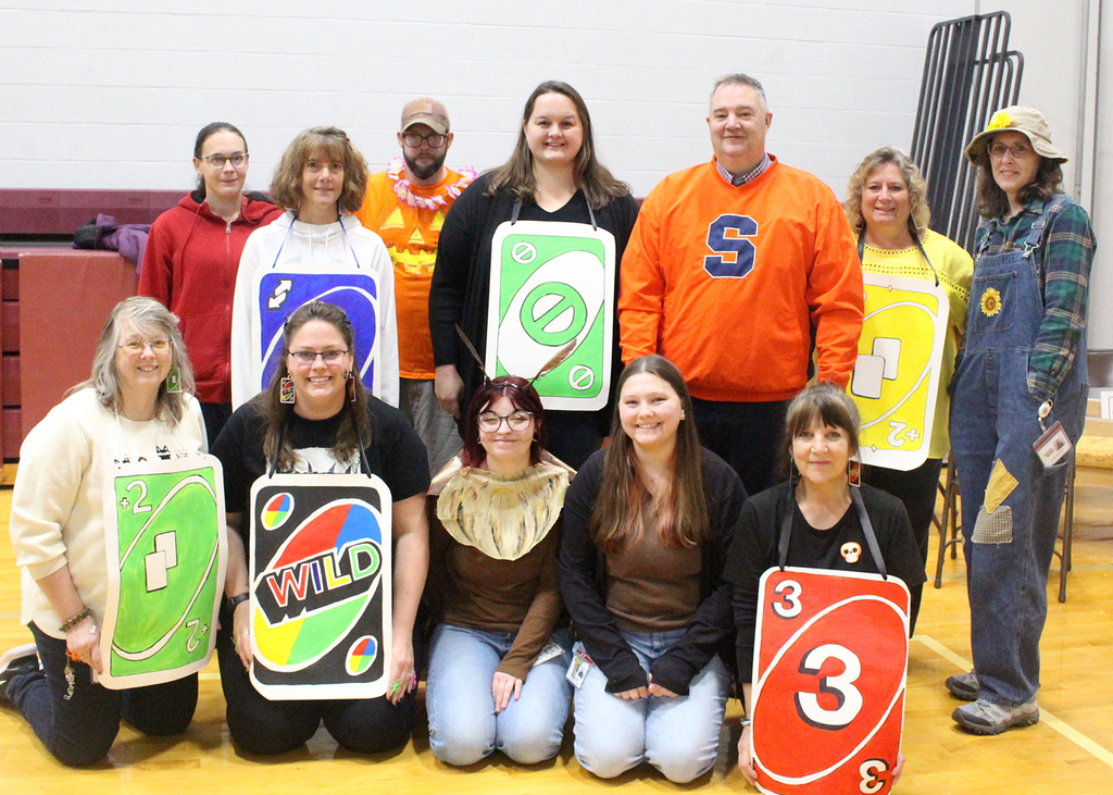 support services staff pose for group picture, many in costume