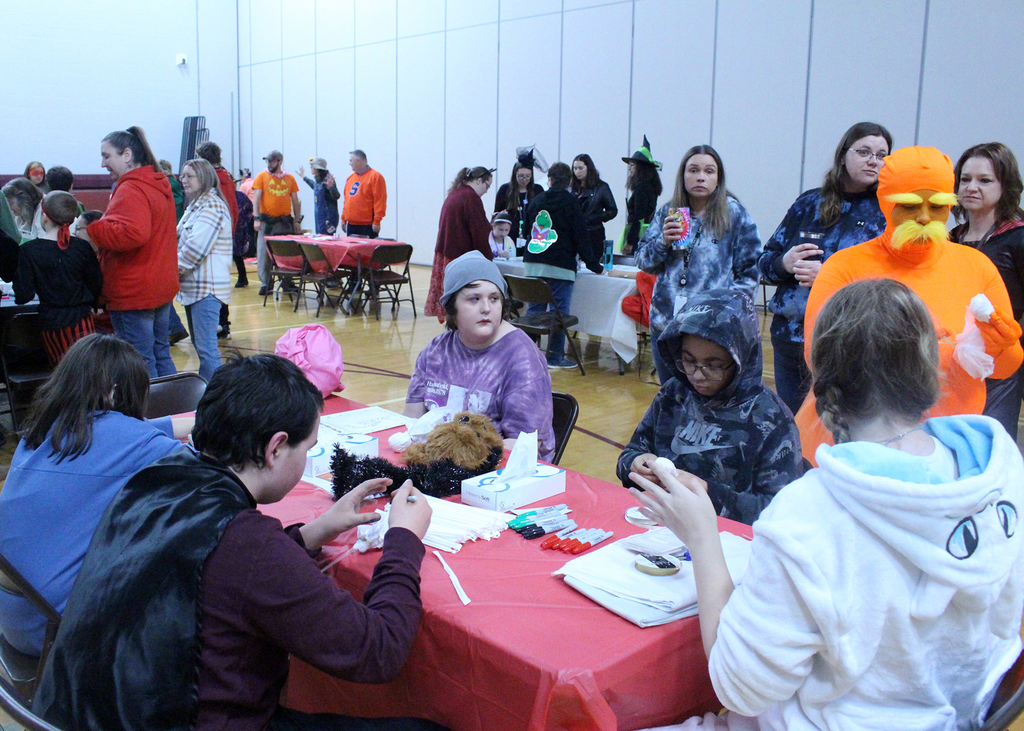 students at Halloween activities in gym