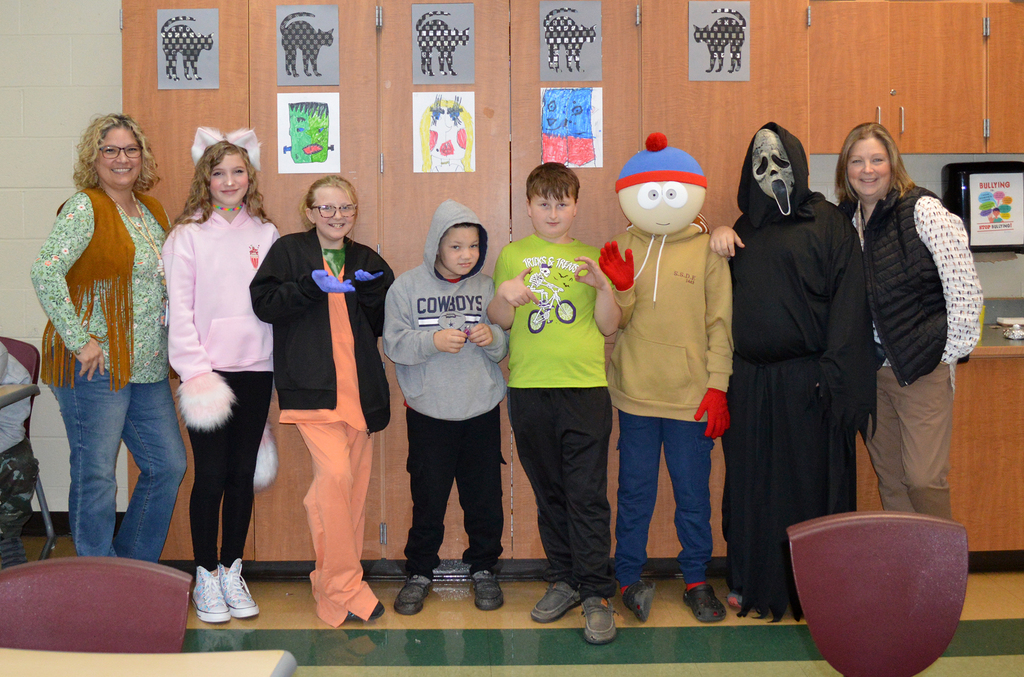 2 adults and 6 kids in costume