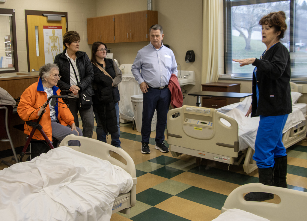 Instructor Barbara Fletcher-Blake speaks about the nursing lab to Scott Harrold and his family
