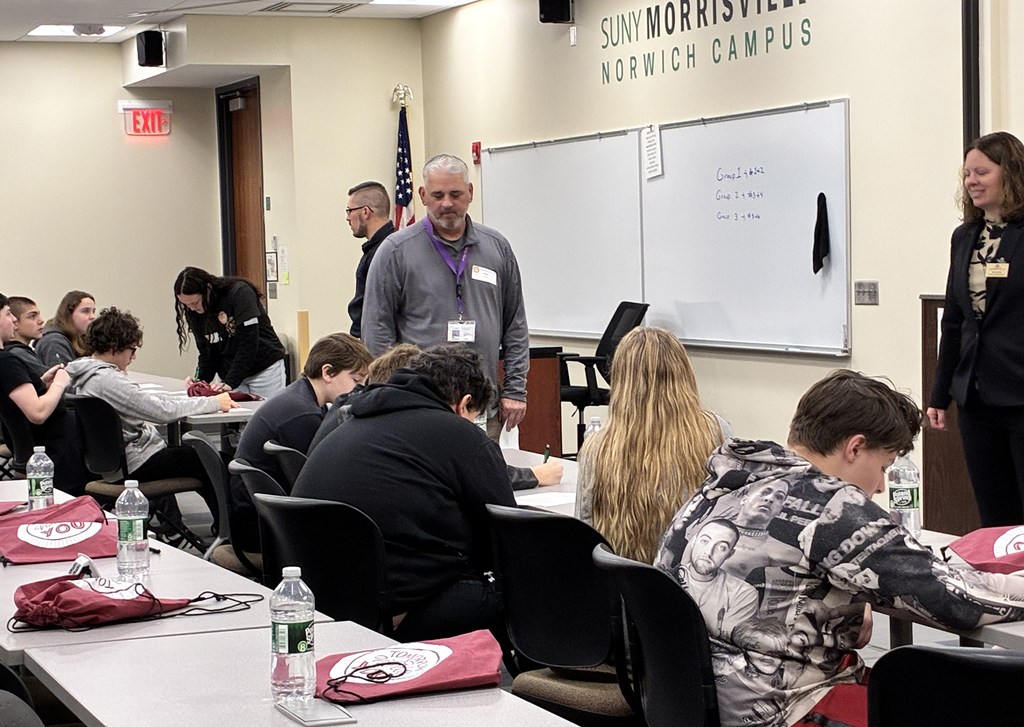 law enforcement employees oversee an exercise with students