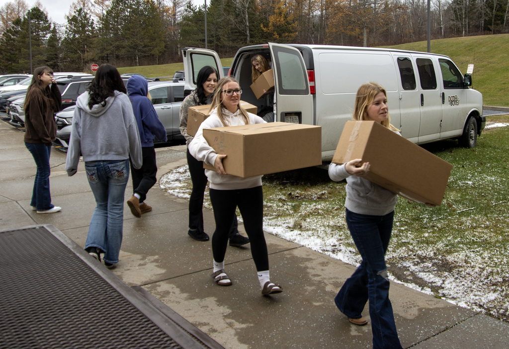 students unload boxes of bread