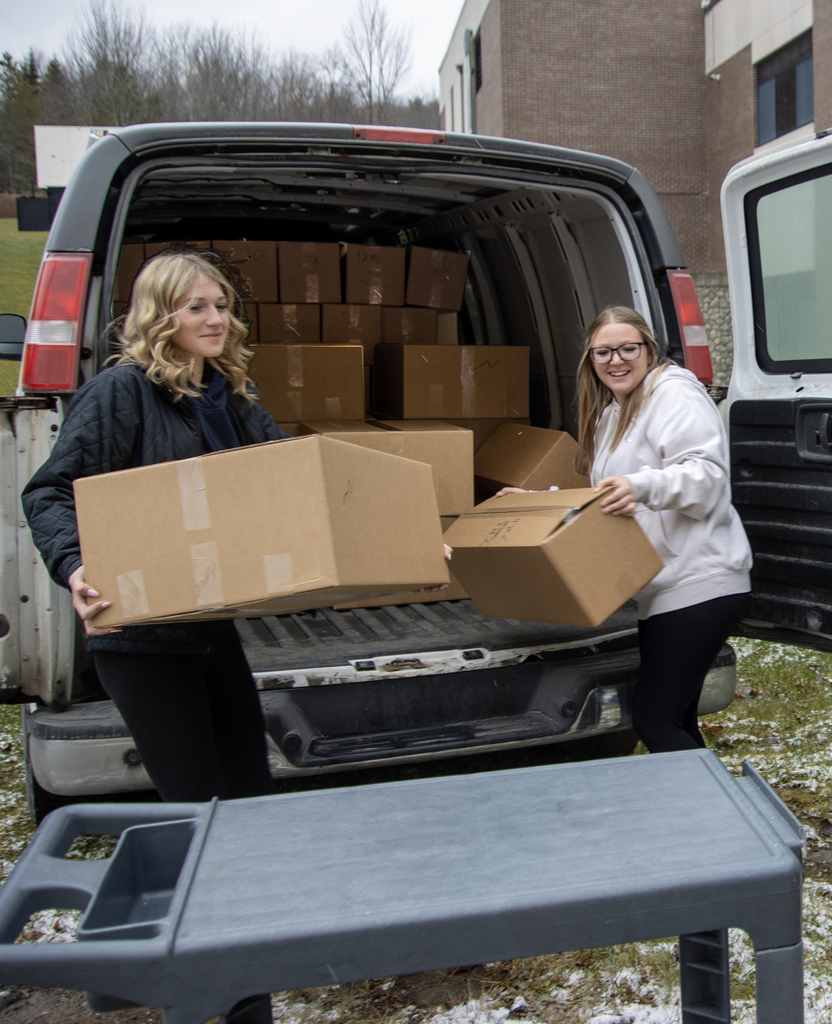 students unload boxes of bread