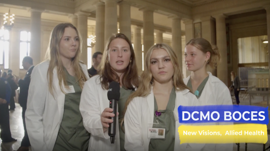 4 New Visions Allied Health students with microphone 