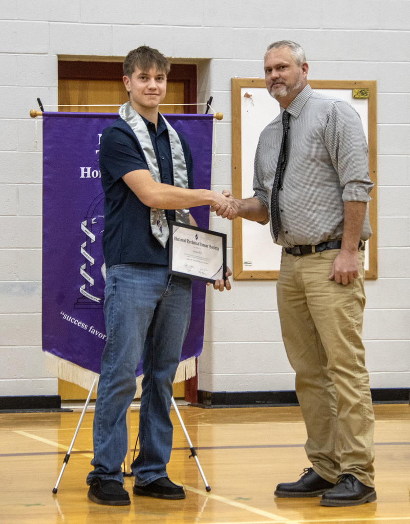 student and teacher handshake