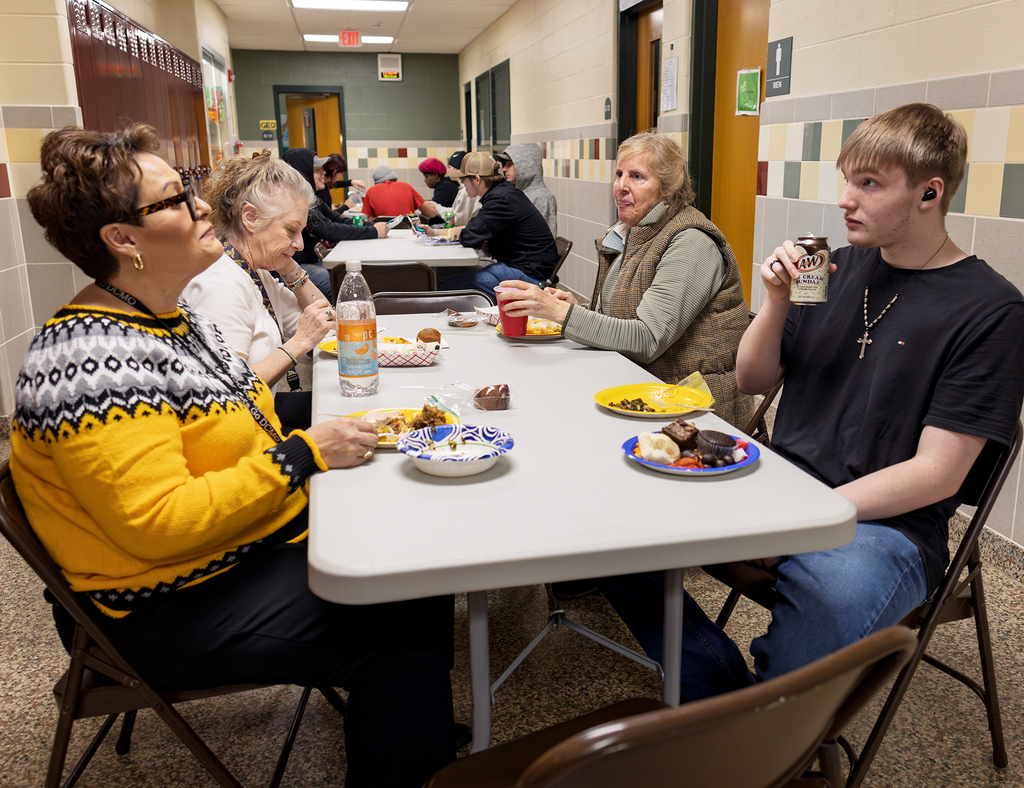 students and staff at table