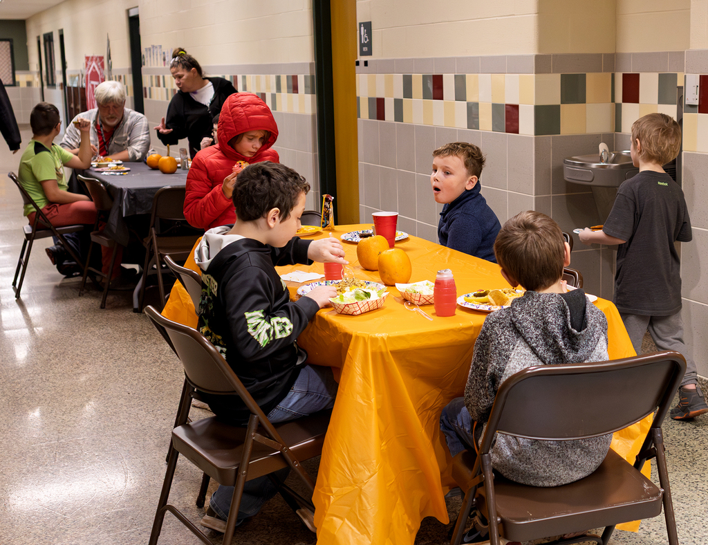 students and staff at tables