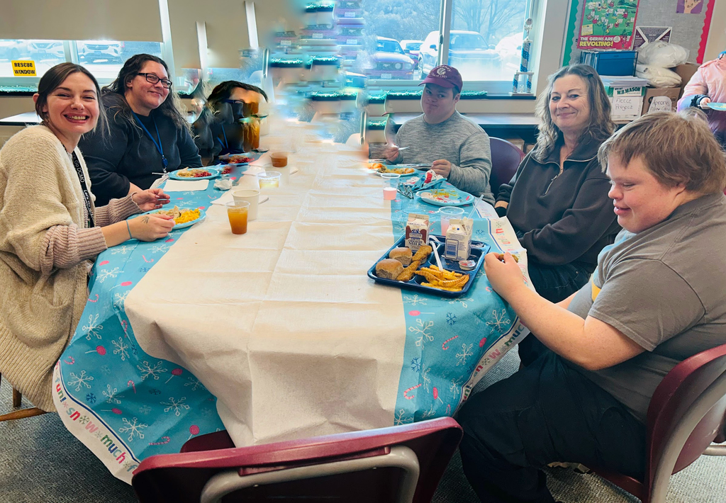 group of students and staff at table