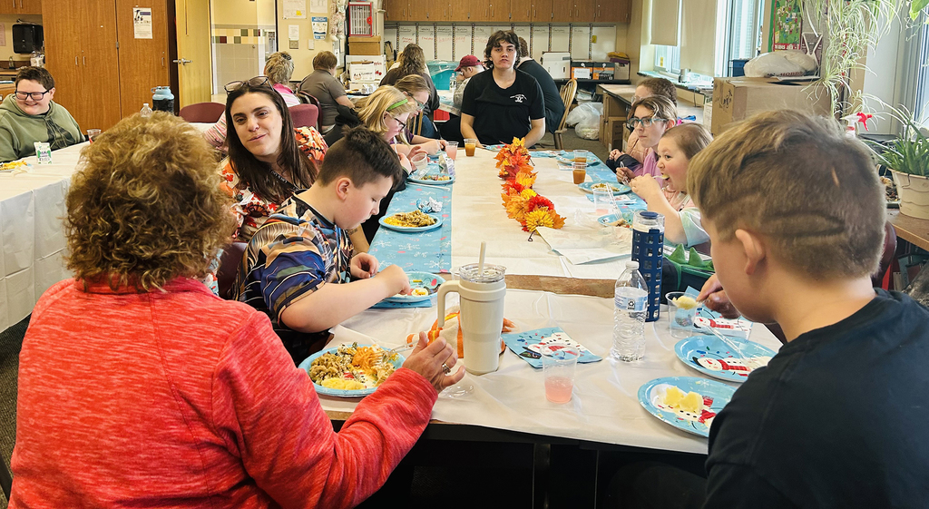 group of students and staff at table