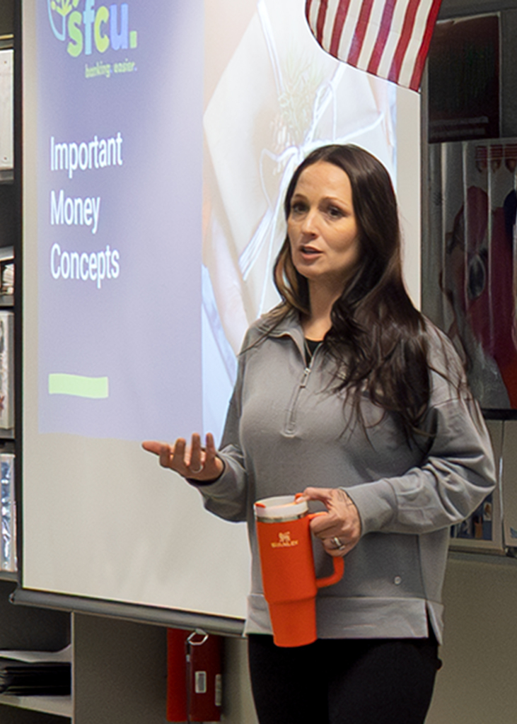 speaker and screen which says "Important Money Concepts"