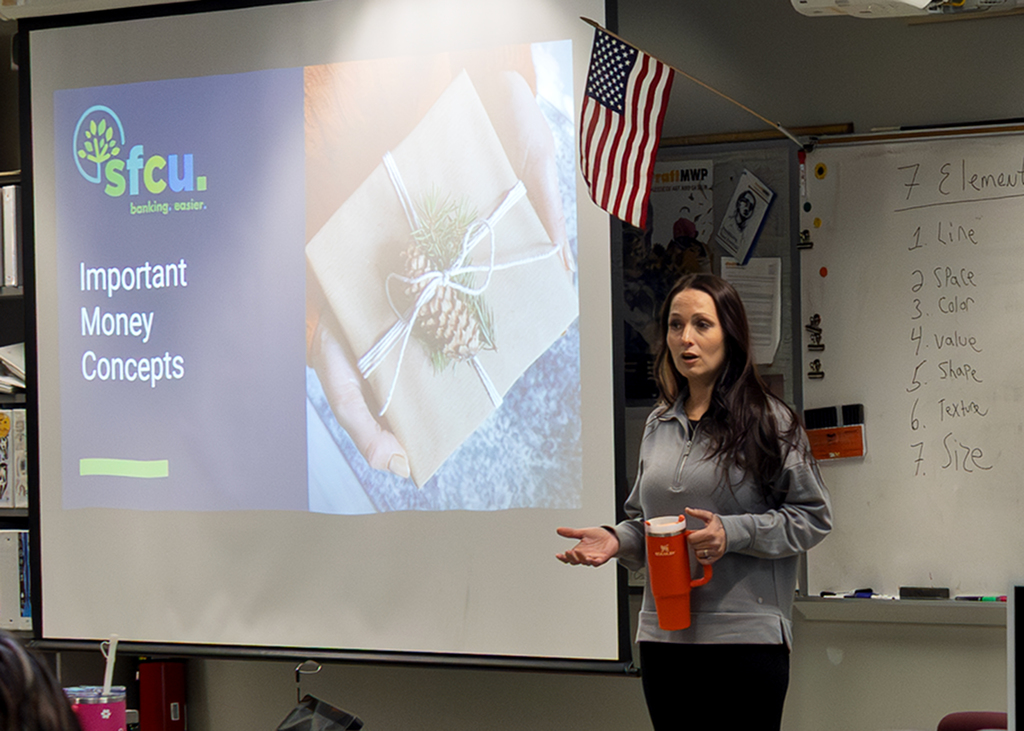 speaker next to screen which says "SFCU. Important Money Concepts