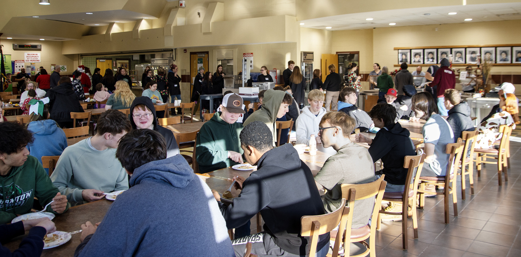 Crowded cafeteria as students enjoy free pancakes