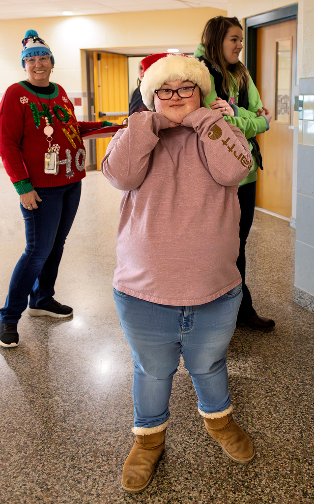 merry student smiles wearing Santa hat