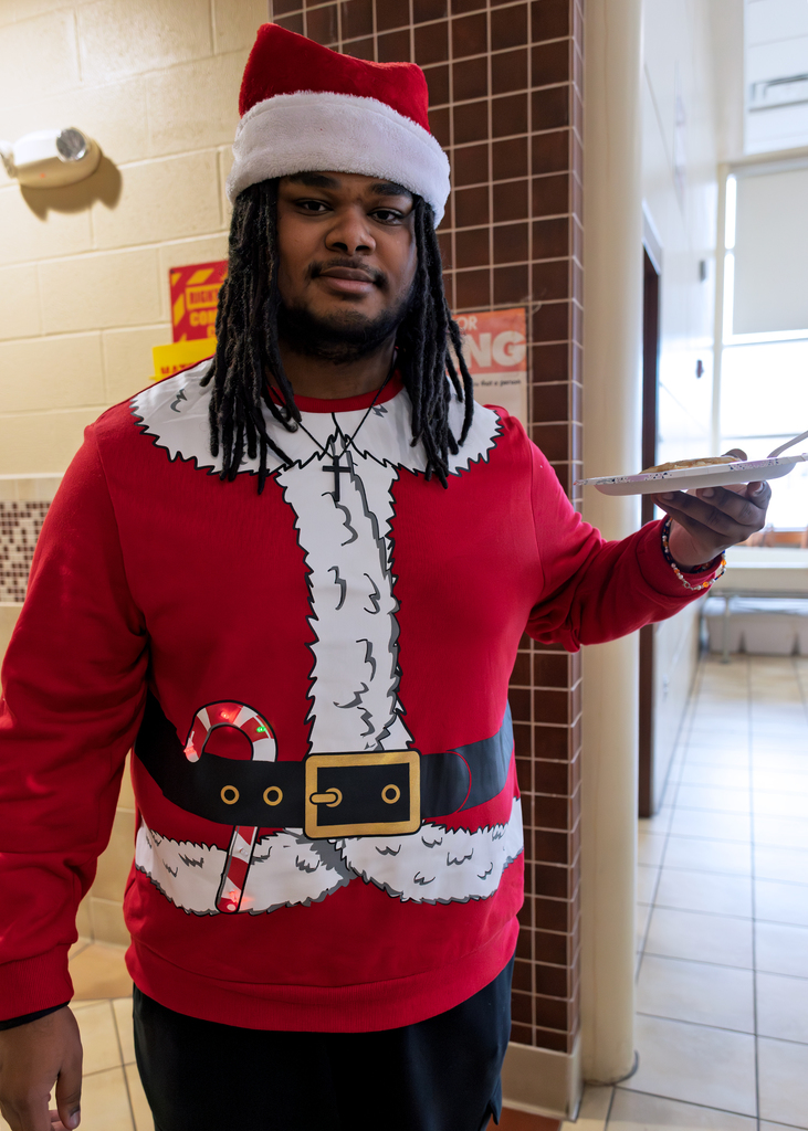 student in santa outfit with pancakes