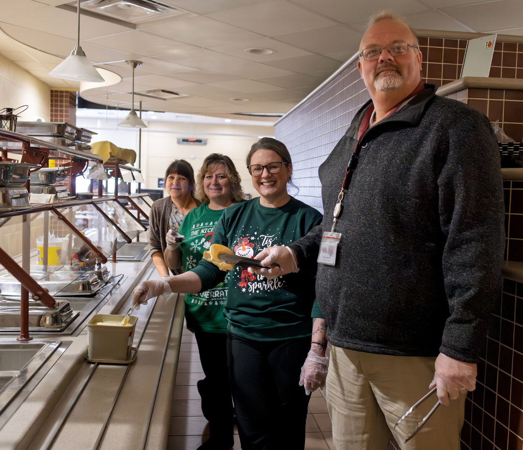 servers pose with  a very, very tall Jason Lawrence