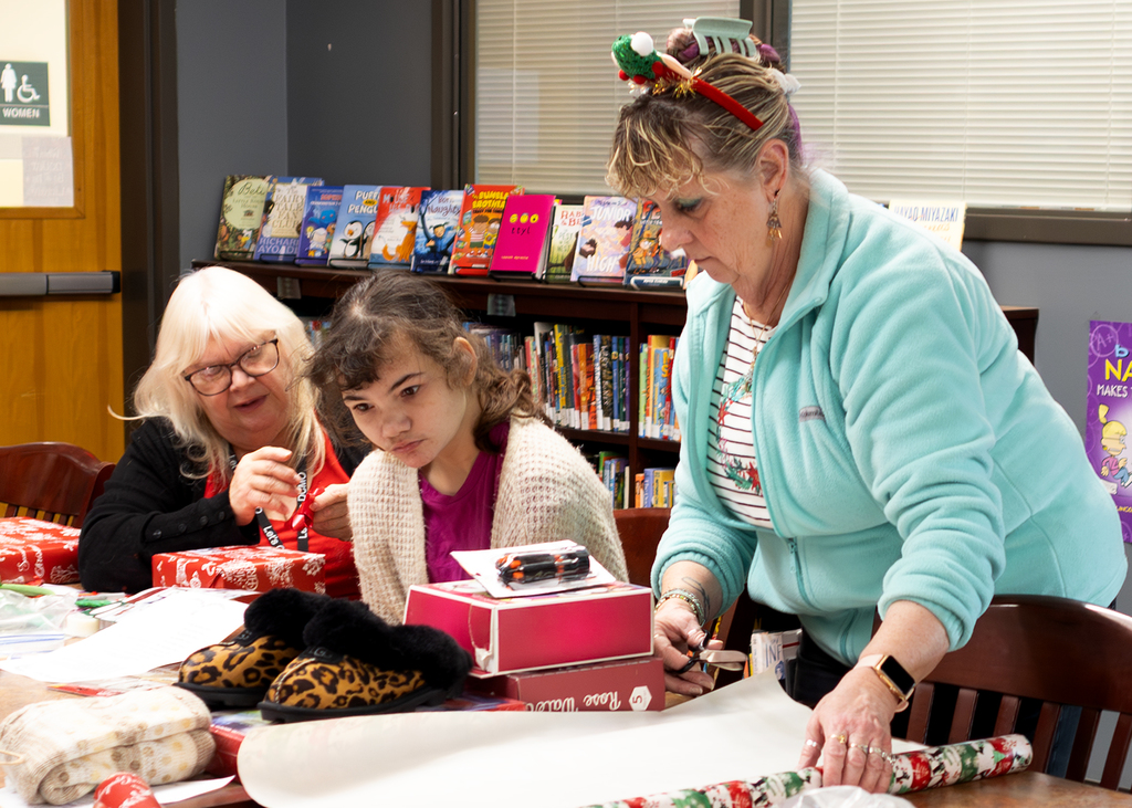 staff and students look at gift options on tables