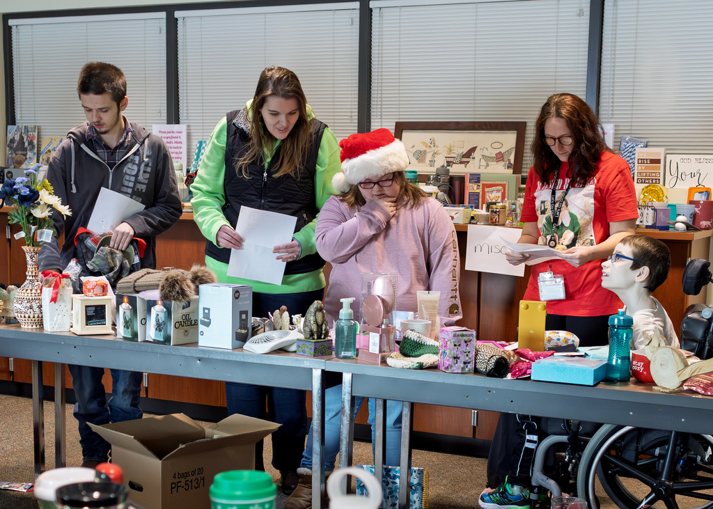 staff and students look at gift options on tables