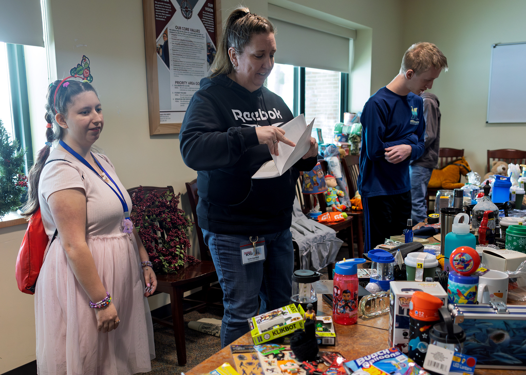 staff and students look at gift options on tables