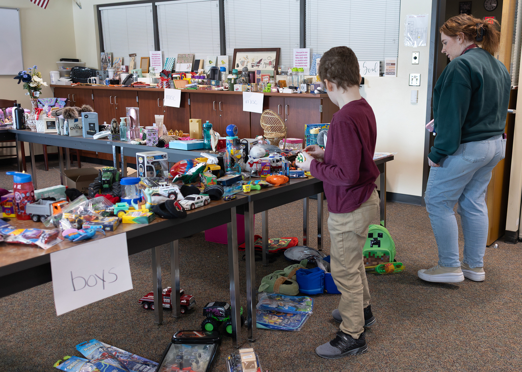 staff and students look at gift options on tables