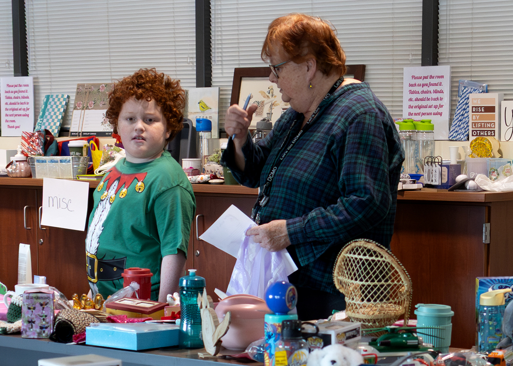 staff and student look at gift options on tables