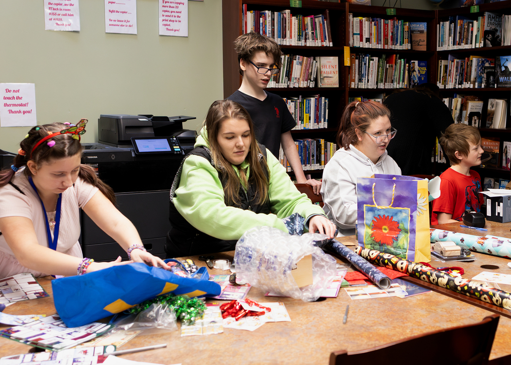 students wrap presents
