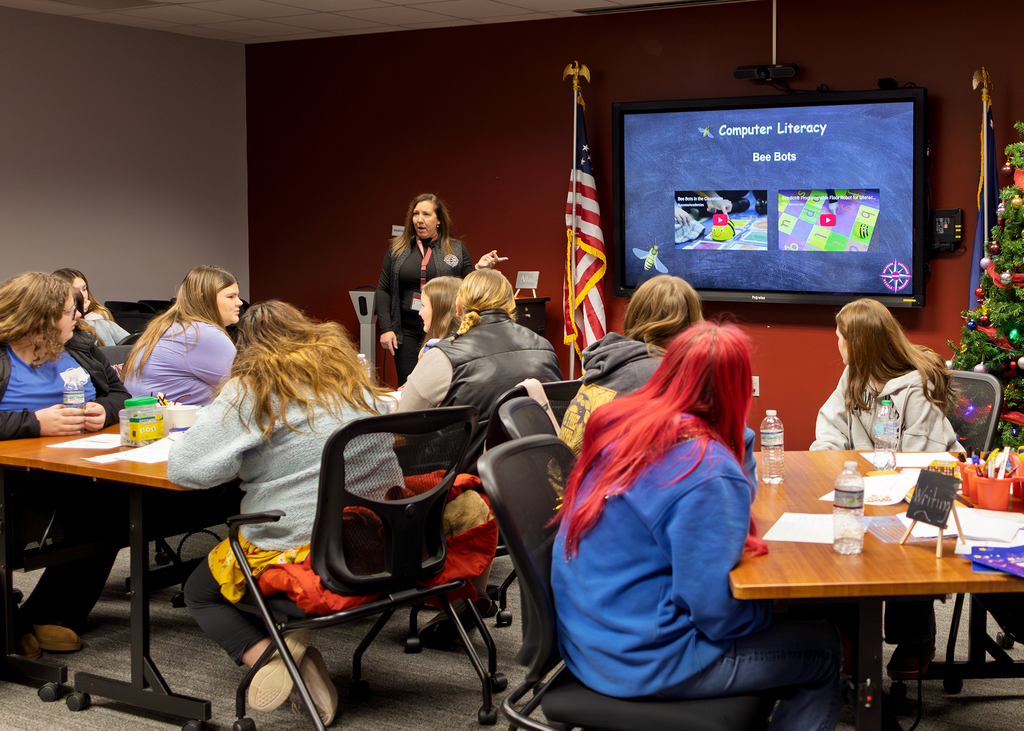presenter speaks to group in conference room