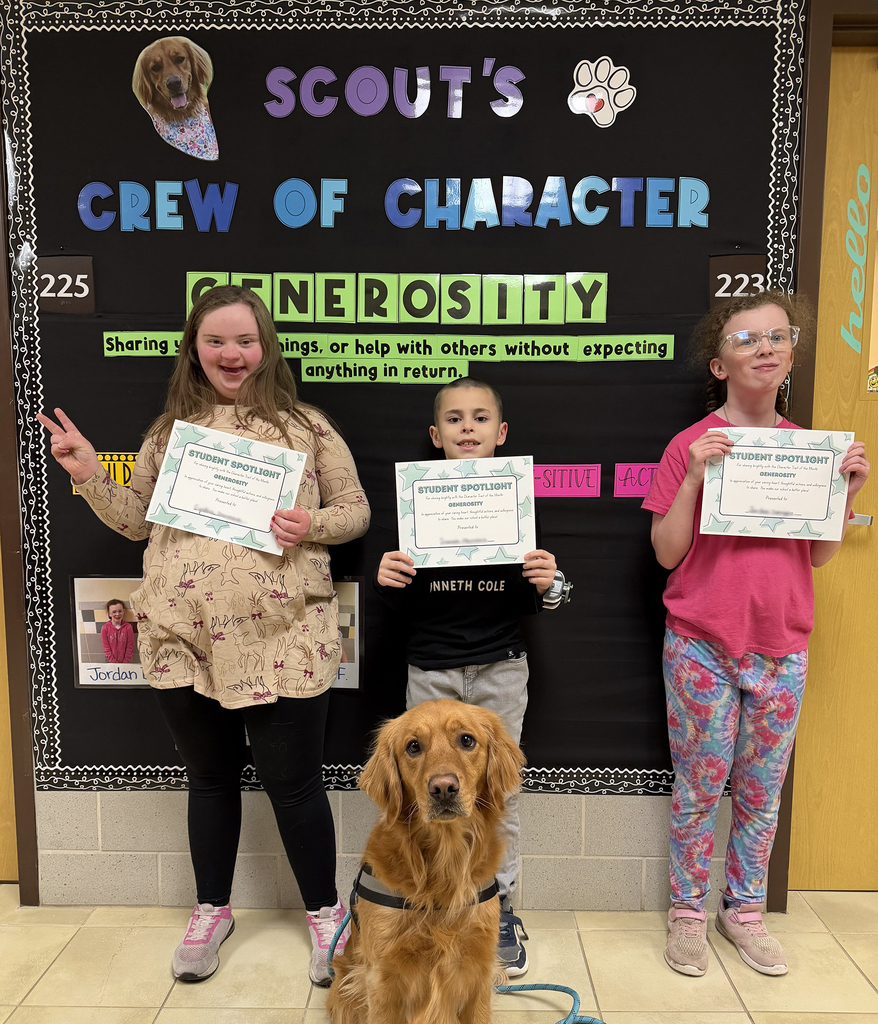 3 students hold certificates and pose with the dog