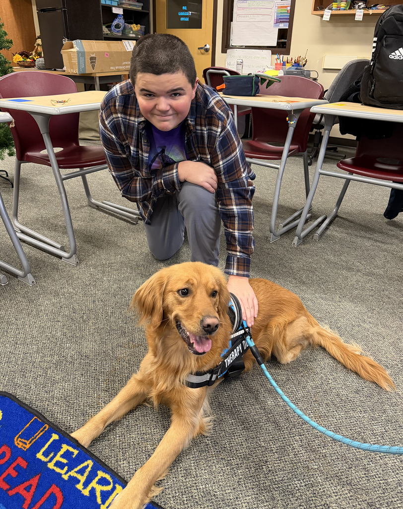 student poses with the dog