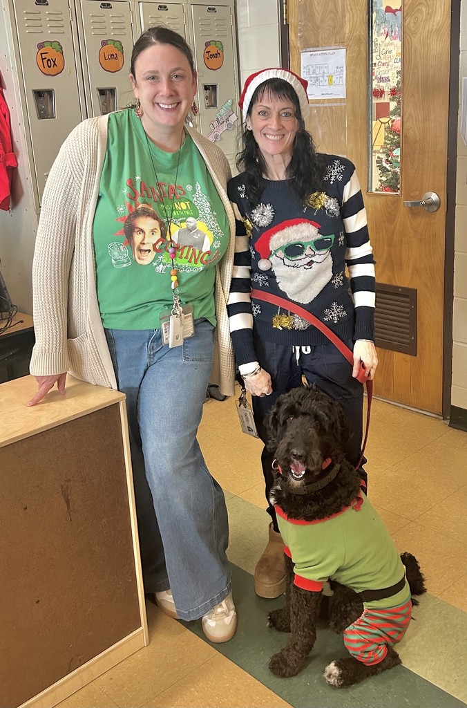 2 dults and a dog in holiday wear