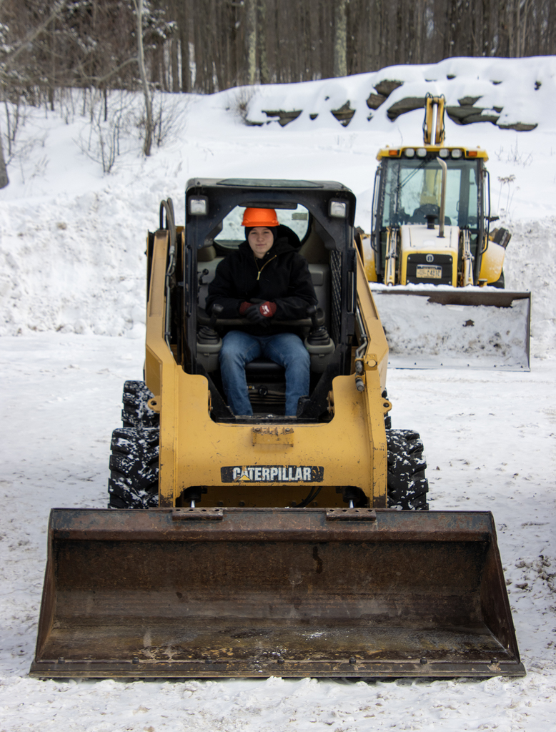 conservation student in a skid steer