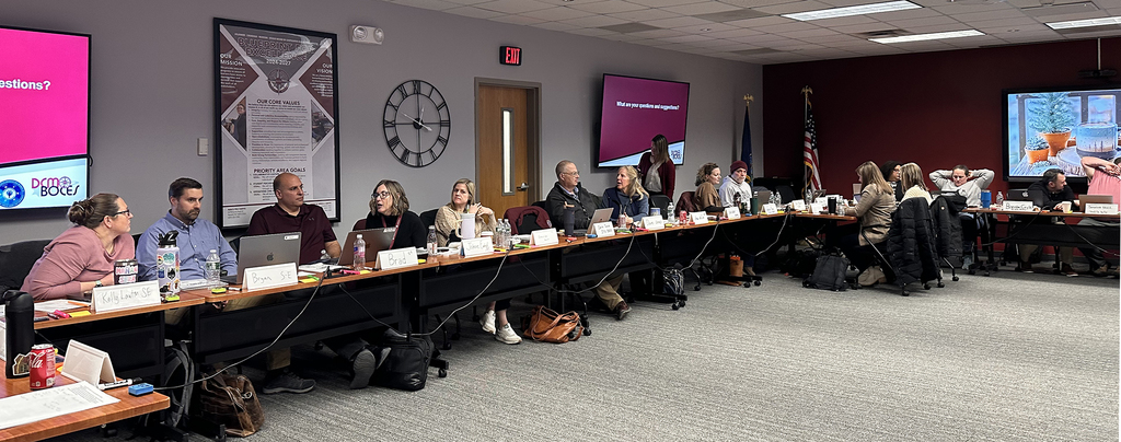 educators in discussion sit at a conference table