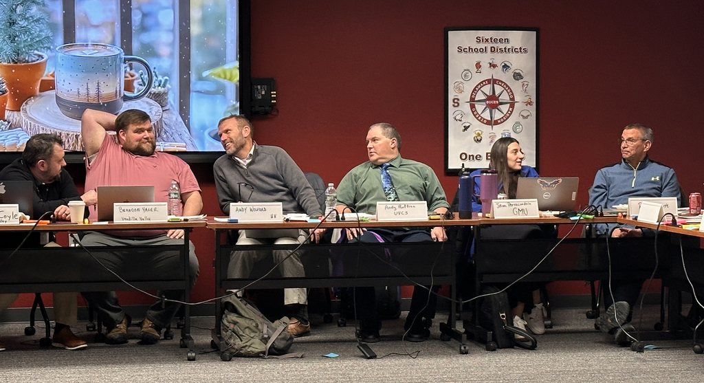 educators in discussion sit at a conference table