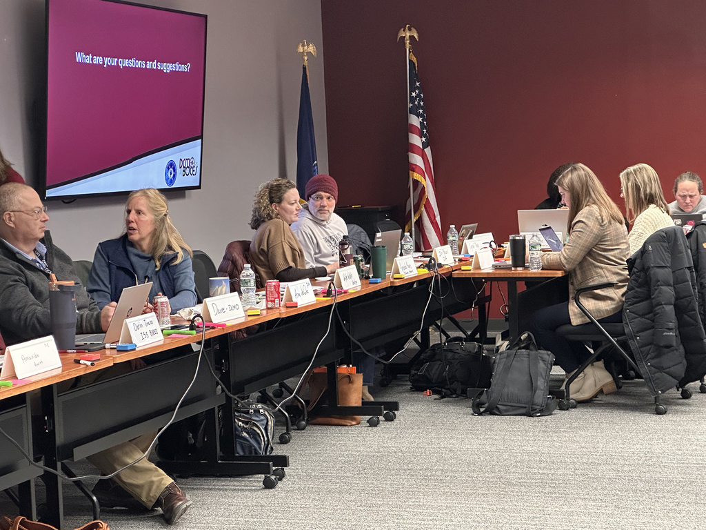 educators in discussion sit at a conference table