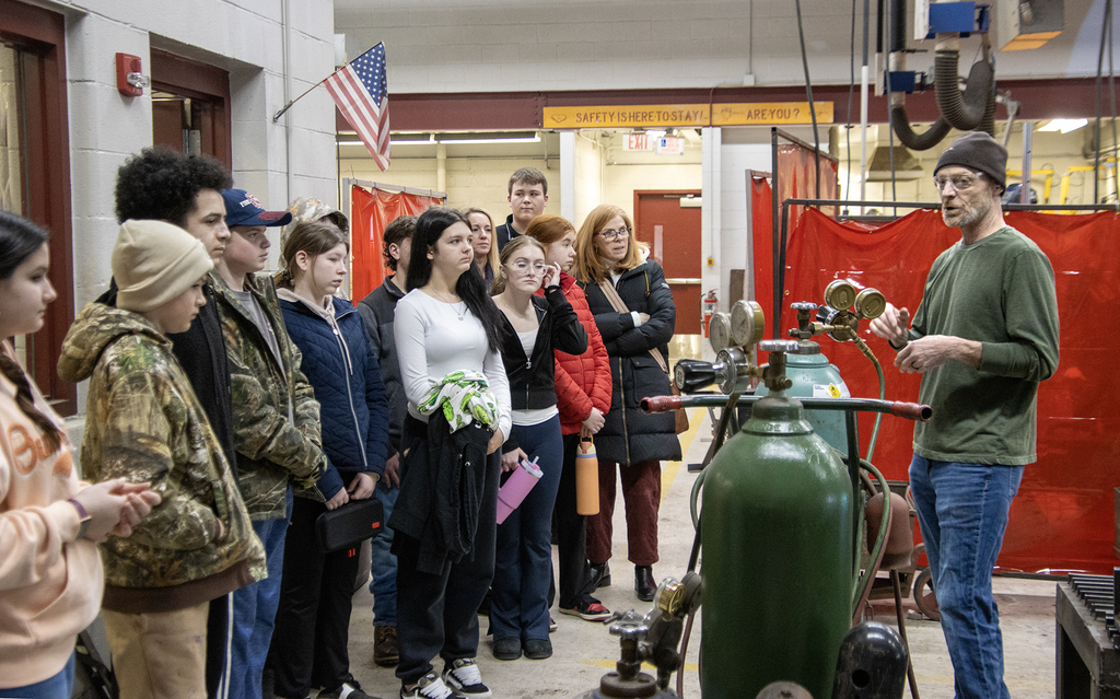 welding teacer speaks to visiting students