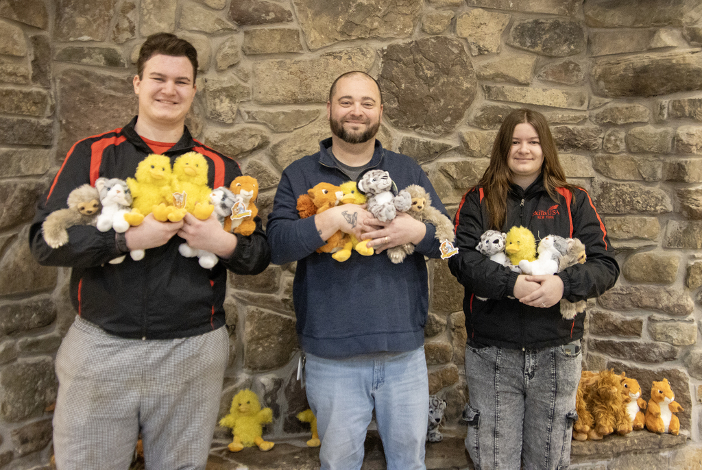Pierce, Dan and Lily holding stuffed animals