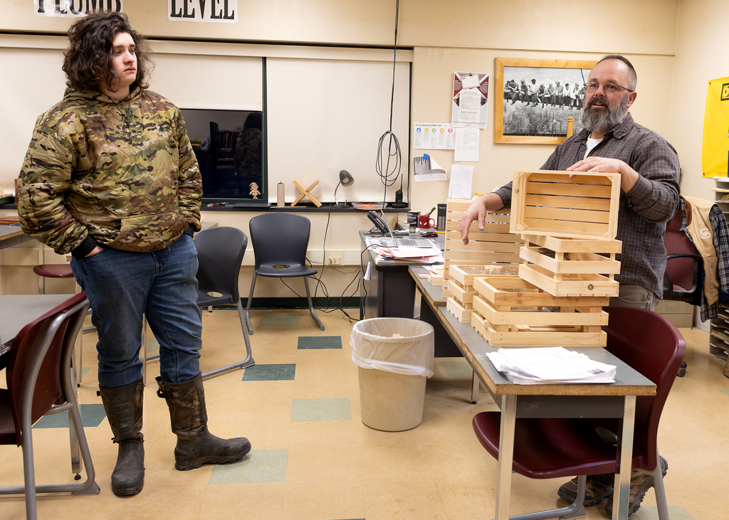 Carpentry teacher speaks with student