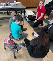 educator with kid goat and students