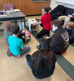 educator with kid goat and students