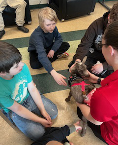 educator and students with kid goat