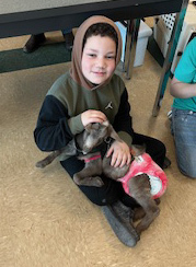 student with kid goat