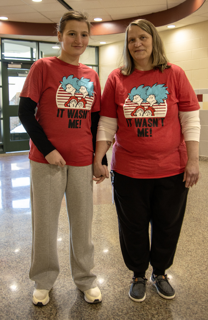 a student and an aide wearing Dr. Seuss shirts